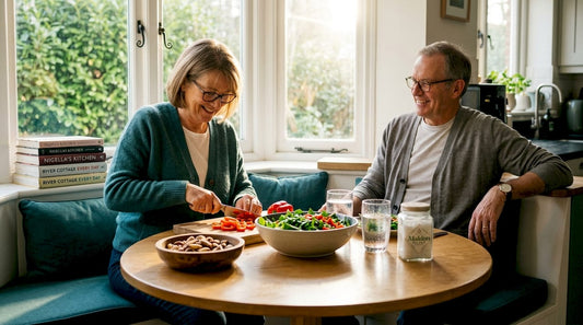 Older adults chopping vegetables in bright kitchen